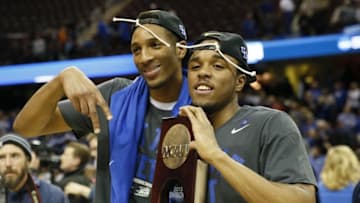 Mar 28, 2015; Cleveland, OH, USA; Kentucky Wildcats forward Marcus Lee (00) and guard EJ Floreal (24) pose with the trophy after the game against the Notre Dame Fighting Irish in the finals of the midwest regional of the 2015 NCAA Tournament at Quicken Loans Arena. Kentucky won 68-66. Mandatory Credit: Rick Osentoski-USA TODAY Sports
