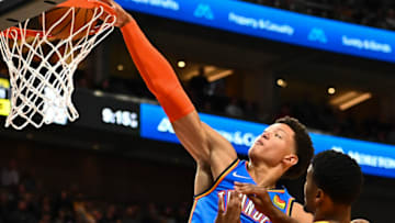 Isaiah Roby #22 of the Oklahoma City Thunder dunks over Jared Butler #13 of the Utah Jazz during a game at Vivint Smart Home Arena on October 20, 2021 in Salt Lake City, Utah. NOTE TO USER: User expressly acknowledges and agrees that, by downloading and or using this photograph, User is consenting to the terms and conditions of the Getty Images License Agreement. (Photo by Alex Goodlett/Getty Images)