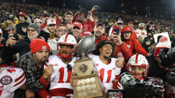 Nov 25, 2022; Iowa City, Iowa, USA; Nebraska Cornhuskers quarterback Casey Thompson (11) and defensive back Braxton Clark (11) hold the Heroes Trophy with fans after defeating the Iowa Hawkeyes at Kinnick Stadium. Mandatory Credit: Reese Strickland-USA TODAY Sports