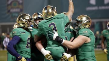 Nov 21, 2015; Boston, MA, USA; Notre Dame Fighting Irish wide receiver Amir Carlisle (3) celebrates a touchdown surrounded by teammates during the first quarter against the Boston College Eagles at Fenway Park. Mandatory Credit: Greg M. Cooper-USA TODAY Sports