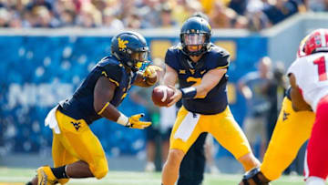 Sep 10, 2016; Morgantown, WV, USA; West Virginia Mountaineers quarterback Skyler Howard (3) hands the ball off to West Virginia Mountaineers running back Rushel Shell (7) during the second quarter against the Youngstown State Penguins at Milan Puskar Stadium. Mandatory Credit: Ben Queen-USA TODAY Sports