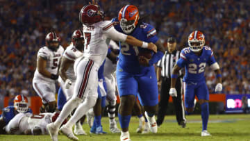 Nov 12, 2022; Gainesville, Florida, USA; Florida Gators defensive lineman Desmond Watson (21) stiff arms South Carolina Gamecocks quarterback Spencer Rattler (7) after he recovered the turn over during the second half at Ben Hill Griffin Stadium. Mandatory Credit: Kim Klement-USA TODAY Sports