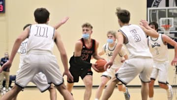 Five Lake Country Lutheran defenders collapse on Brandin Podziemski of St. John's Northwestern Academies during a game on December 15, 2020.Rs5a9032