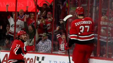 RALEIGH, NC - MARCH 24: Andrei Svechnikov #37 of the Carolina Hurricanes scores the game winning goal in overtime and celebrates with teammate Justin Faulk #27 during an NHL game against the Montreal Canadiens March 24, 2019 at PNC Arena in aleigh, North Carolina. (Photo by Gregg Forwerck/NHLI via Getty Images)
