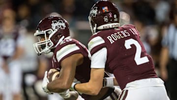 STARKVILLE, MISSISSIPPI - OCTOBER 16: Quarterback Will Rogers #2 of the Mississippi State Bulldogs hands the ball off to running back Dillon Johnson #23 of the Mississippi State Bulldogs during their game against the Alabama Crimson Tide at Davis Wade Stadium on October 16, 2021 in Starkville, Mississippi. (Photo by Michael Chang/Getty Images)