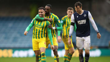 LONDON, ENGLAND - FEBRUARY 09: Hal Robson-Kanu of West Bromwich Albion shares a laugh with Semi Ajayi after clashing with Jake Cooper of Millwall during the Sky Bet Championship match between Millwall and West Bromwich Albion at The Den on February 09, 2020 in London, England. (Photo by Alex Pantling/Getty Images)