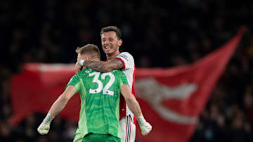 LONDON, ENGLAND - DECEMBER 15: Aaron Ramsdale celebrates Arsenal's second goal with Ben White during the Premier League match between Arsenal and West Ham United at Emirates Stadium on December 15, 2021 in London, England. (Photo by Visionhaus/Getty Images)