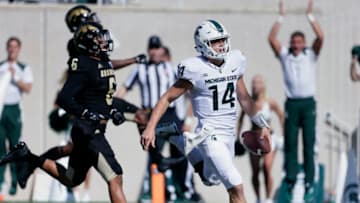 EAST LANSING, MI - SEPTEMBER 09: Quarterback Brian Lewerke #14 of the Michigan State Spartans scores on a 61 yards carry while being pursued by linebacker Asantay Brown #6 of the Western Michigan Broncos during the first half at Spartan Stadium on September 9, 2017 in East Lansing, Michigan. (Photo by Duane Burleson/Getty Images)