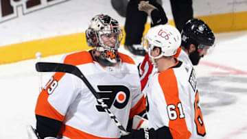 NEWARK, NEW JERSEY - JANUARY 28: Carter Hart #79 and Justin Braun #61 of the Philadelphia Flyers celebrate their 3-1 victory over the New Jersey Devils at the Prudential Center on January 28, 2021 in Newark, New Jersey. (Photo by Bruce Bennett/Getty Images)