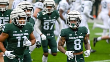 Michigan State's Jalen Nailor, left, runs to the sideline with teammates during the spring football game on Saturday, April 24, 2021, at Spartan Stadium in East Lansing.210424 Msu Spring Game 033a