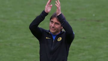 MILAN, ITALY - MAY 23: Antonio Conte Head coach of Internazionale applauds the public as he enters the field of play to collect his winner's medal and celebrate with the Scudetto following the Serie A match between FC Internazionale Milano and Udinese Calcio at Stadio Giuseppe Meazza on May 23, 2021 in Milan, Italy. Sporting stadiums around Italy remain under strict restrictions due to the Coronavirus Pandemic as Government social distancing laws prohibit fans inside venues resulting in games being played behind closed doors (Photo by Jonathan Moscrop/Getty Images)