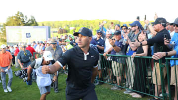 FARMINGDALE, NEW YORK - MAY 18: Brooks Koepka of the United States tosses his ball as he walks from the 18th green during the third round of the 2019 PGA Championship at the Bethpage Black course on May 18, 2019 in Farmingdale, New York. (Photo by Warren Little/Getty Images)