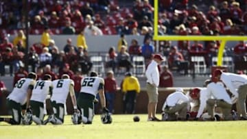 Nov 8, 2014; Norman, OK, USA; Baylor Bears players kneel as Oklahoma Sooners quarterback Trevor Knight (9) lays injured during the second half at Gaylord Family - Oklahoma Memorial Stadium. Mandatory Credit: Kevin Jairaj-USA TODAY Sports