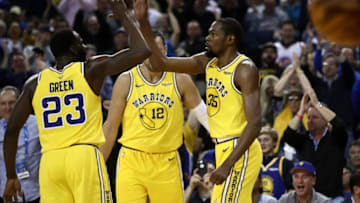OAKLAND, CALIFORNIA - APRIL 02: Kevin Durant #35 of the Golden State Warriors is congratulated by Draymond Green #23 and Andrew Bogut #12 after he dunked the ball against the Denver Nuggets at ORACLE Arena on April 02, 2019 in Oakland, California. NOTE TO USER: User expressly acknowledges and agrees that, by downloading and or using this photograph, User is consenting to the terms and conditions of the Getty Images License Agreement. (Photo by Ezra Shaw/Getty Images)
