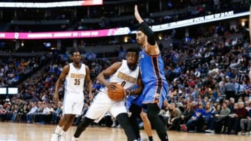 Jan 19, 2016; Denver, CO, USA; Denver Nuggets guard Emmanuel Mudiay (0) dribbles the ball as Oklahoma City Thunder center Enes Kanter (11) defends in the second quarter at the Pepsi Center. Mandatory Credit: Isaiah J. Downing-USA TODAY Sports