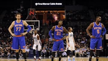 Jan 14, 2014; Charlotte, NC, USA; New York Knicks forward center Andrea Bargnani (77), guard forward Iman Shumpert (21), and guard Tim Hardaway Jr. look around after coach Mike Woodson (not shown) is called on a technical foul during the second half of the game at Time Warner Cable Arena. Bobcats win 108-98. Mandatory Credit: Sam Sharpe-USA TODAY Sports