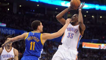 Jan 16, 2015; Oklahoma City, OK, USA; Oklahoma City Thunder forward Kevin Durant (35) attempts a shot against Golden State Warriors guard Klay Thompson (11) during the fourth quarter at Chesapeake Energy Arena. Mandatory Credit: Mark D. Smith-USA TODAY Sports