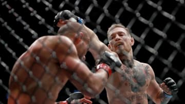 NEW YORK, NY - NOVEMBER 12: (R-L) Conor McGregor of Ireland punches Eddie Alvarez in their UFC lightweight championship fight in their UFC lightweight championship fight during the UFC 205 event at Madison Square Garden on November 12, 2016 in New York City. (Photo by Michael Reaves/Getty Images )