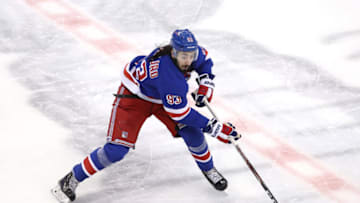 Mika Zibanejad #93 of the New York Rangers takes the puck in the third period against the New York Islanders during an exhibition game. (Photo by Andre Ringuette/Freestyle Photo/Getty Images)