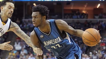 Mar 16, 2016; Memphis, TN, USA; Minnesota Timberwolves forward Andrew Wiggins (22) dribbles as Memphis Grizzlies forward Matt Barnes (22) defends at FedExForum. Minnesota defeated Memphis 114-108. Mandatory Credit: Nelson Chenault-USA TODAY Sports