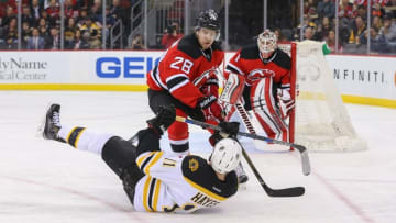 Mar 29, 2016; Newark, NJ, USA; New Jersey Devils defenseman Damon Severson (28) hits Boston Bruins right wing Jimmy Hayes (11) during the first period at Prudential Center. Mandatory Credit: Ed Mulholland-USA TODAY Sports