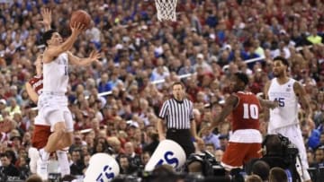 Apr 4, 2015; Indianapolis, IN, USA; Kentucky Wildcats guard Devin Booker (1) lays the ball up past Wisconsin Badgers guard Bronson Koenig (24) in the second half of the 2015 NCAA Men's Division I Championship semi-final game at Lucas Oil Stadium. Mandatory Credit: Robert Deutsch-USA TODAY Sports