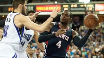 Mar 16, 2015; Sacramento, CA, USA; Atlanta Hawks forward Paul Millsap (4) looks to pass the ball against Sacramento Kings forward Omri Casspi (18) and forward Jason Thompson (34) during the fourth quarter at Sleep Train Arena. The Atlanta Hawks defeated the Sacramento Kings 110-103. Mandatory Credit: Ed Szczepanski-USA TODAY Sports