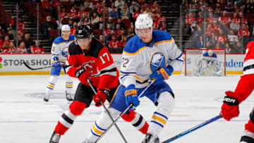 NEWARK, NEW JERSEY - OCTOBER 23: Tage Thompson #72 of the Buffalo Sabres battles for the puck in the first period against Yegor Sharangovich #17 of the New Jersey Devils at Prudential Center on October 23, 2021 in Newark, New Jersey. (Photo by Jim McIsaac/Getty Images)