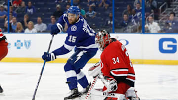 TAMPA, FL - SEPTEMBER 18: Carolina Hurricanes goaltender Petr Mrazek (34) makes a save on a redirected shot from Tampa Bay Lightning center Andy Andreoff (15) in the second period of the NHL preseason game between the Carolina Hurricanes and Tampa Bay Lightning on September 18, 2018, at Amalie Arena in Tampa, FL. (Photo by Mark LoMoglio/Icon Sportswire via Getty Images)