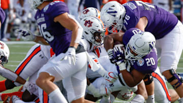Auburn footballJan 1, 2021; Orlando, FL, USA; Northwestern Wildcats running back Cam Porter (20) is stopped by Auburn Tigers defensive back Jamien Sherwood (20) as Wildcats running back Evan Hull (26) and offensive lineman Ethan Wiederkehr (76) block during the first quarter at Camping World Stadium. Mandatory Credit: Reinhold Matay-USA TODAY Sports