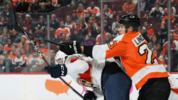 PHILADELPHIA, PA - NOVEMBER 13: Oskar Lindblom #23 of the Philadelphia Flyers checks Mike Matheson #19 of the Florida Panthers while battling for position in front of Roberto Luongo #1 on November 13, 2018 at the Wells Fargo Center in Philadelphia, Pennsylvania. (Photo by Len Redkoles/NHLI via Getty Images)