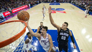 PHILADELPHIA, PA - NOVEMBER 25: Dario Saric #9 of the Philadelphia 76ers attempts a lay up against Aaron Gordon #00 of the Orlando Magic in the second quarter at the Wells Fargo Center on November 25, 2017 in Philadelphia, Pennsylvania. The 76ers defeated the Magic 130-111. NOTE TO USER: User expressly acknowledges and agrees that, by downloading and or using this photograph, User is consenting to the terms and conditions of the Getty Images License Agreement. (Photo by Mitchell Leff/Getty Images)