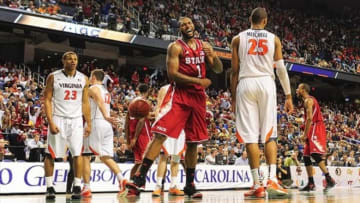 Mar 15, 2013; Greensboro, NC, USA; North Carolina State Wolfpack forward Richard Howell (1) and guard Lorenzo Brown (2) react after a basket by forward C.J. Leslie (5) as Virginia Cavaliers guards Justin Anderson (23) and Joe Harris (12) and forward Akil Mitchell (25) look on in the second half. The Wolfpack defeated the Cavaliers 75-56 during the quarterfinals of the ACC tournament at Greensboro Coliseum. Mandatory Credit: Bob Donnan-USA TODAY Sports