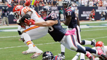 HOUSTON - OCTOBER 17: Thomas Jones #20 of the Kansas City Chies is brought down from behind by Brian Cushing #56 of the Houston Texans as Kareem Jackson #25 misses the tackle at Reliant Stadium on October 17, 2010 in Houston, Texas. (Photo by Bob Levey/Getty Images)