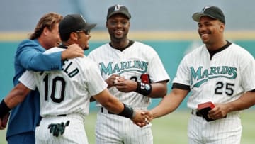 Florida Marlins 1997 World Series players, from left, Darren Daulton, Gary Sheffield, Charles Johnson and Bobby Bonilla congratulate each other after receiving their World Series championship rings during a ceromony held 05 April at Pro Player Stadium in Miami, Florida. The Marlins beat the Cleveland Indians in the best-of-seven series to win the 1997 World Series. AFP PHOTO/Rhona WISE (Photo by RHONA WISE / AFP) (Photo by RHONA WISE/AFP via Getty Images)