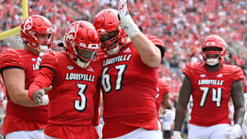 Louisville Cardinals quarterback Malik Cunningham celebrates with offensive lineman Luke Kandra after scoring a touchdown. USA Today.