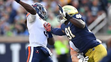 Sep 28, 2019; South Bend, IN, USA; Virginia Cavaliers quarterback Bryce Perkins (3) throws under pressure from Notre Dame Fighting Irish defensive lineman Adetokunbo Ogundeji (91) in the third quarter at Notre Dame Stadium. Mandatory Credit: Matt Cashore-USA TODAY Sports