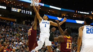 PITTSBURGH, PA - MARCH 15: Trevon Duval #1 of the Duke Blue Devils goes up for a shot between Roland Griffin #11 and TK Edogi #13 of the Iona Gaels during the first half of the game in the first round of the 2018 NCAA Men's Basketball Tournament at PPG PAINTS Arena on March 15, 2018 in Pittsburgh, Pennsylvania. (Photo by Justin K. Aller/Getty Images)