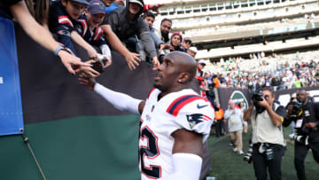 EAST RUTHERFORD, NEW JERSEY - OCTOBER 30: Devin McCourty #32 of the New England Patriots celebrates with fans after a game against the New York Jets at MetLife Stadium on October 30, 2022 in East Rutherford, New Jersey. (Photo by Elsa/Getty Images)