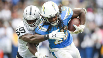 CARSON, CA - OCTOBER 07: Running back Melvin Gordon #28 of the Los Angeles Chargers is tackled by linebacker Tahir Whitehead #59 of the Oakland Raiders in the third quarter at StubHub Center on October 7, 2018 in Carson, California. (Photo by Harry How/Getty Images)