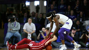 Jan 7, 2017; Manhattan, KS, USA; Oklahoma Sooners forward Matt Freeman (5) and Kansas State Wildcats forward D.J. Johnson (4) go after a loose ball during a game at Fred Bramlage Coliseum. The Wildcats won the game, 75-64. Mandatory Credit: Scott Sewell-USA TODAY Sports