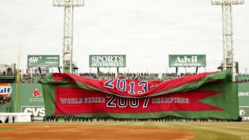 Apr 4, 2014; Boston, MA, USA; A 2013 World Series championship banner for the Boston Red Sox is unfurled on the Green Monster during pre-game ceremonies before the start of the game against the Milwaukee Brewers at Fenway Park. Mandatory Credit: David Butler II-USA TODAY Sports