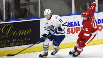 MISSISSAUGA, ON - DECEMBER 14: Cole Schwindt #11 of the Mississauga Steelheads controls the puck against Tye Kartye #12 of the Sault Ste. Marie Greyhounds during OHL game action on December 14, 2018 at Paramount Fine Foods Centre in Mississauga, Ontario, Canada. Mississauga defeated Oshawa 4-2. (Photo by Graig Abel/Getty Images)
