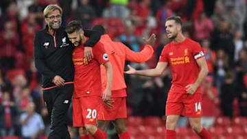 Liverpool's German manager Jurgen Klopp (L) celebrates on the pitch with Liverpool's English midfielder Adam Lallana (2nd L) after the English Premier League football match between Liverpool and Leicester City at Anfield in Liverpool, north west England on September 10, 2016.Liverpool won the game 4-1. / AFP / Paul ELLIS / RESTRICTED TO EDITORIAL USE. No use with unauthorized audio, video, data, fixture lists, club/league logos or 'live' services. Online in-match use limited to 75 images, no video emulation. No use in betting, games or single club/league/player publications. / (Photo credit should read PAUL ELLIS/AFP/Getty Images)
