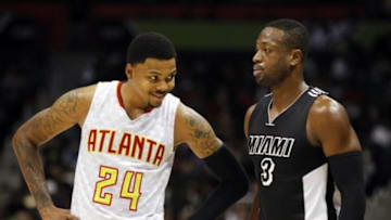 Dec 14, 2015; Atlanta, GA, USA; Atlanta Hawks forward Kent Bazemore (24) talks to Miami Heat guard Dwyane Wade (3) in the second quarter at Philips Arena. Mandatory Credit: Brett Davis-USA TODAY Sports