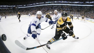 BOSTON, MA - MAY 02: Tampa Bay Lightning left wing Chris Kunitz (14) and Boston Bruins right defenseman Kevan Miller (86) vie for the puck along the glass during Game 3 of the Second Round between the Boston Bruins and the Tampa Bay Lightning on May 2, 2018, at TD Garden in Boston, Massachusetts. The Lightning defeated the Bruins 4-1. (Photo by Fred Kfoury III/Icon Sportswire via Getty Images)