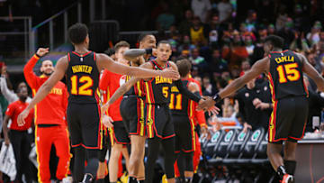 Mar 28, 2023; Atlanta, Georgia, USA; Atlanta Hawks guard Dejounte Murray (5) reacts with forward De'Andre Hunter (12) and center Clint Atlanta Hawks. Mandatory Credit: Brett Davis-USA TODAY Sports