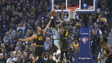 SAN FRANCISCO, CALIFORNIA - MAY 07: Ja Morant #12 of the Memphis Grizzlies drives to the basket and shoots over Stephen Curry #30 and Jonathan Kuminga #00 of the Golden State Warriors during the first half of Game Three of the Western Conference Semifinals of the NBA Playoffs at Chase Center on May 07, 2022 in San Francisco, California. NOTE TO USER: User expressly acknowledges and agrees that, by downloading and or using this photograph, User is consenting to the terms and conditions of the Getty Images License Agreement. (Photo by Thearon W. Henderson/Getty Images)