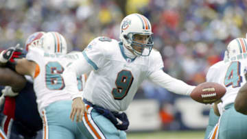 ORCHARD PARK, NY - OCTOBER 17: Jay Fiedler #9 of the Miami Dolphins hands off against the Buffalo Bills on October 17, 2004 at Ralph Wilson Stadium in Orchard Park, New York.(Photo by Rick Stewart/Getty Images)