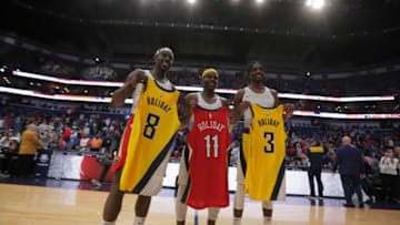 Dec 28, 2019; New Orleans, Louisiana, USA; Brothers New Orleans Pelicans guard Jrue Holiday (left) and Indiana Pacers guard Aaron Holiday (center) and forward Justin Holiday (left) hold up their jerseys following a game at the Smoothie King Center. Mandatory Credit: Derick E. Hingle-USA TODAY Sports